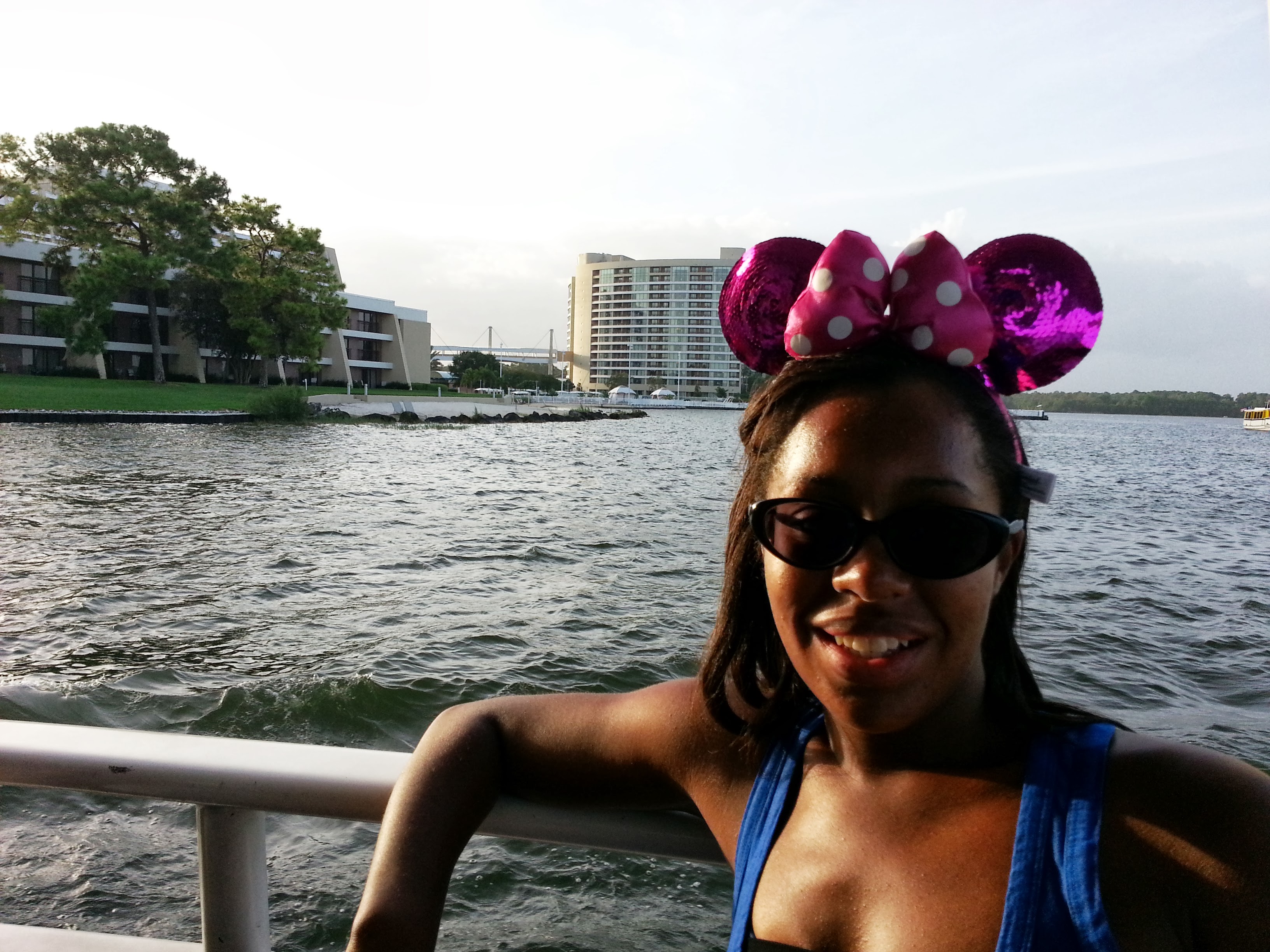 Tamara wearing Minnie Mouse ears near a Disney resort lake