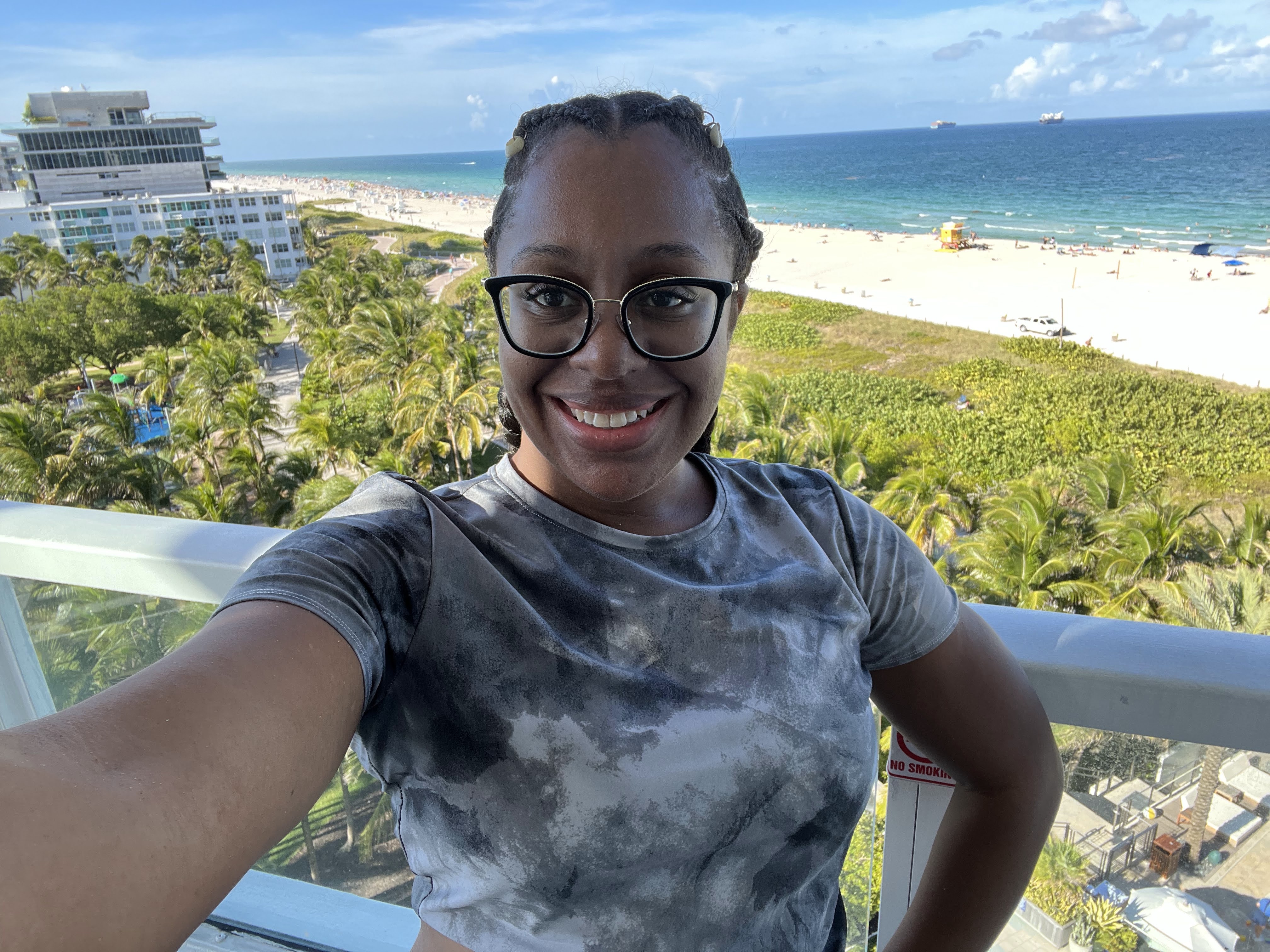Tamara on a balcony overlooking Miami Beach